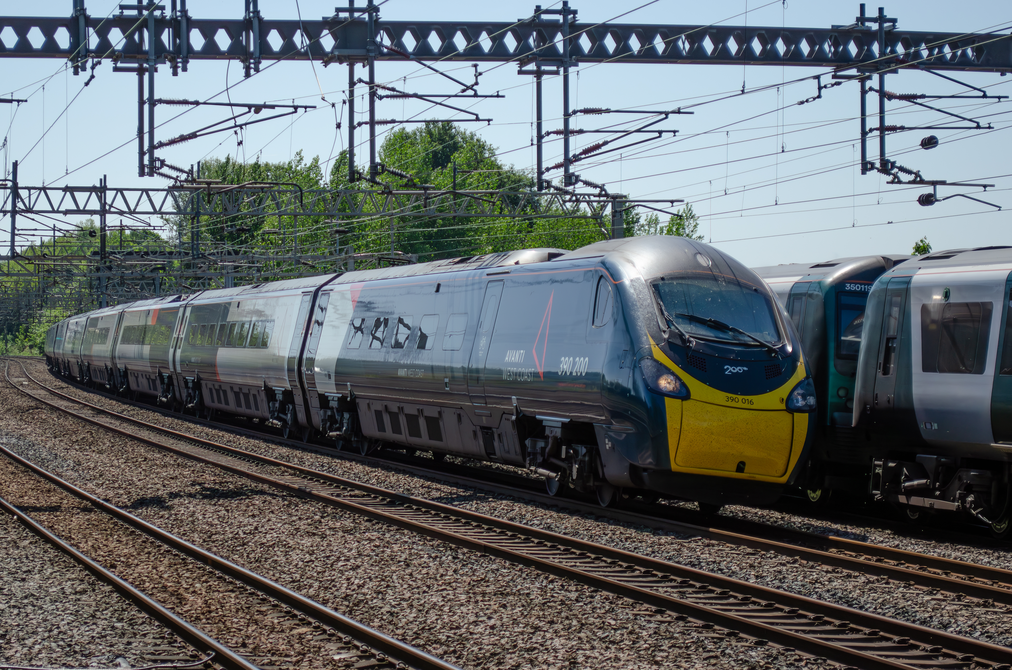 AWC Pendolino No. 390 016 (390 200) passing a pair of 350s at Rugeley Trent Valley. 
